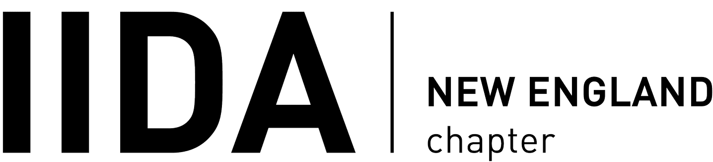 Logo featuring large bold letters IIDA separated by a vertical line from the words New England chapter in a clean, modern font on a light background—reflecting a commitment to workplace wellbeing speaker events and women's leadership development.